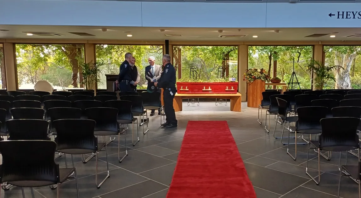 Chapel set up for a funeral service, with the coffin at the front